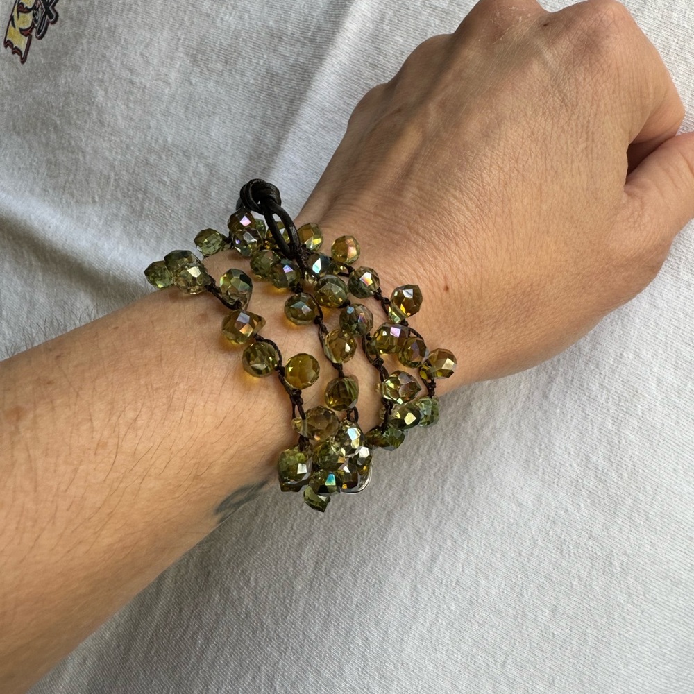Lizou convertible crocheted wrap bracelet with green crystals.
